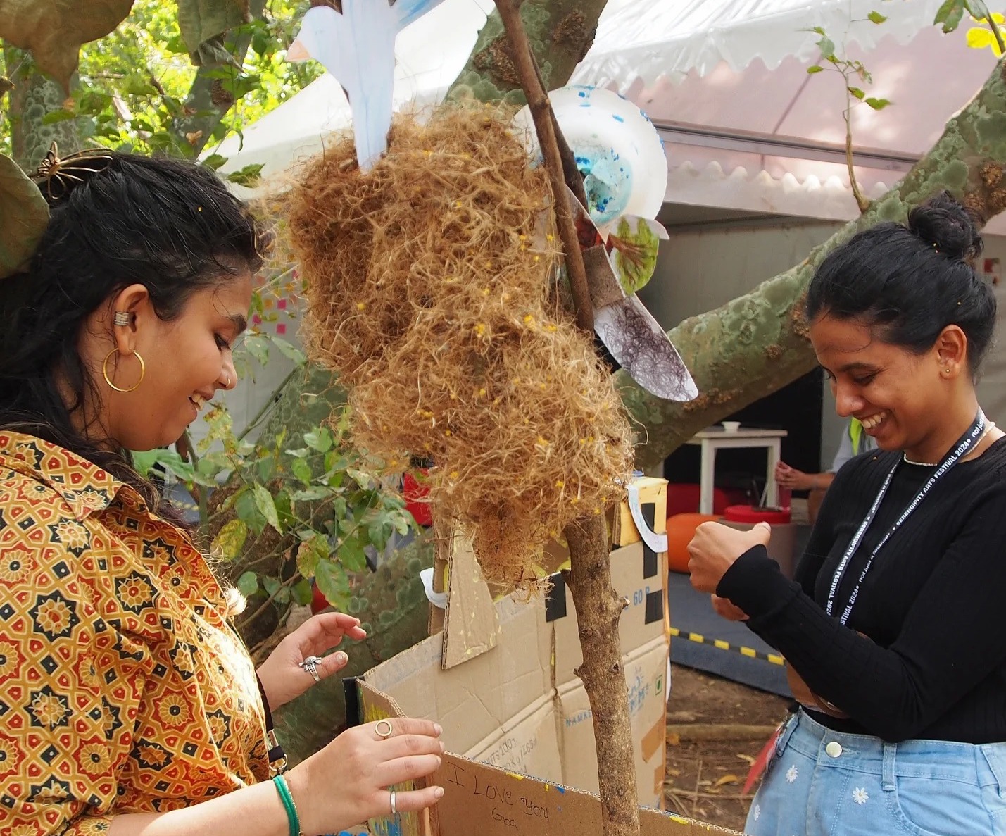 Arts managers workshop at Serendipity Arts Festival, Goa — two participants share a moment around a nest sculpture