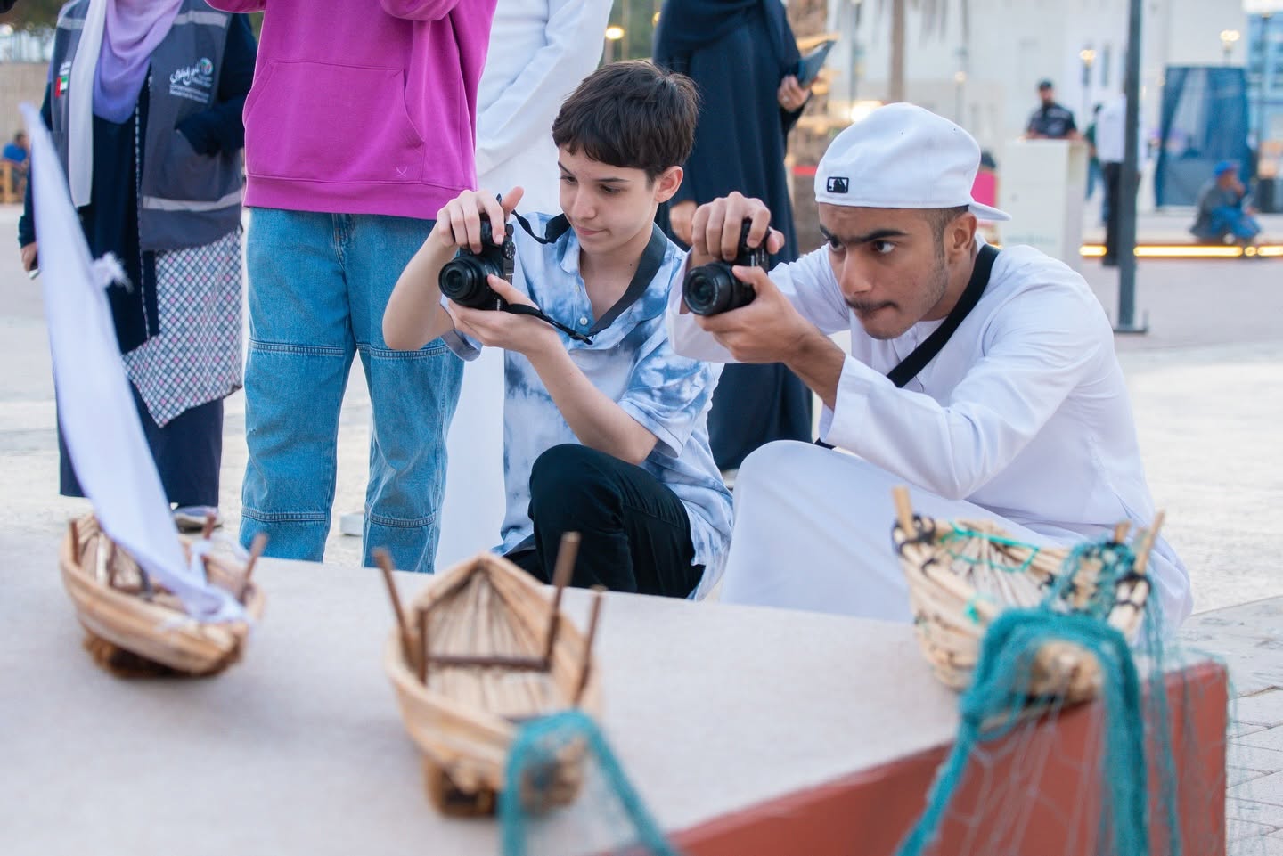 Young children photographing festival art installations and creative activities at an international children's film festival celebration