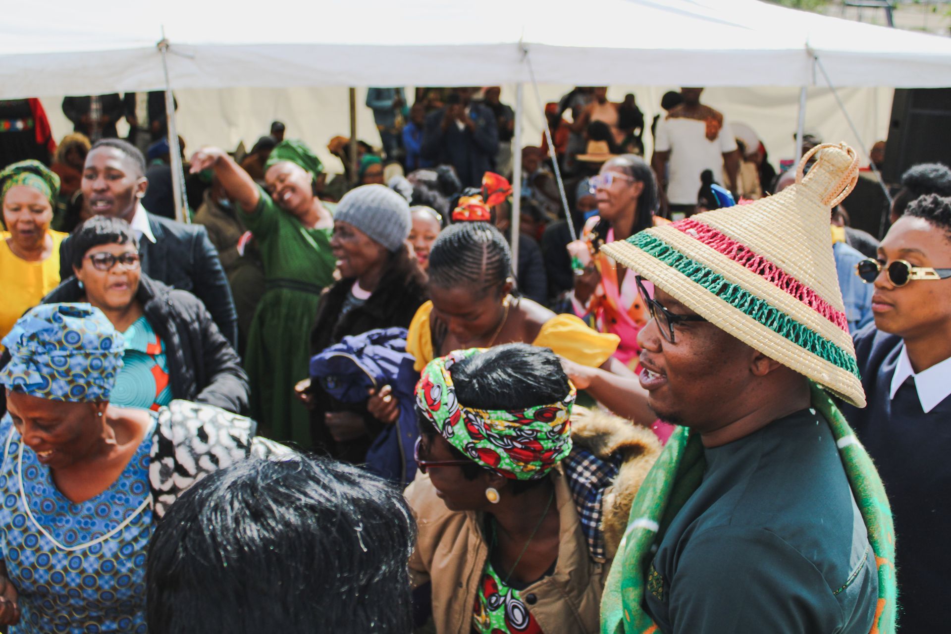 South African cultural festival with designers, crafters, and community members in vibrant traditional textiles and contemporary design wear celebrating local creative culture
