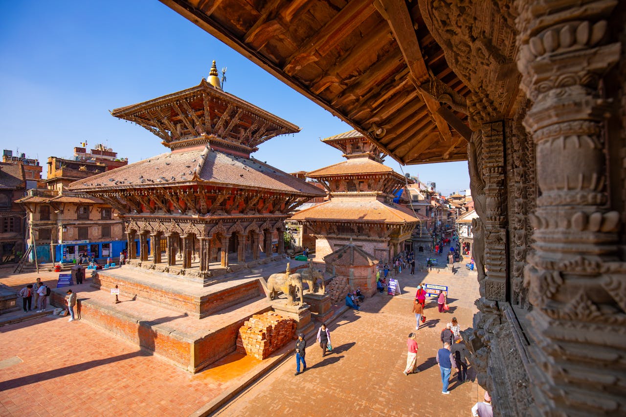 Patan Durbar Square, Nepal — heritage temples and pedestrians on the brick plaza